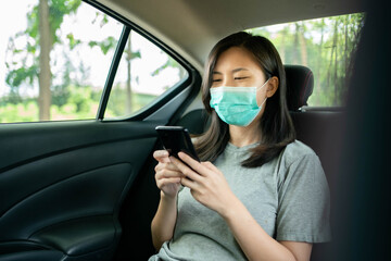 Asian woman wears a face mask to prevent COVID 19 in a car