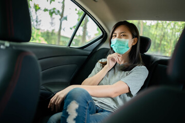 Asian woman wears a face mask to prevent COVID 19 in a car