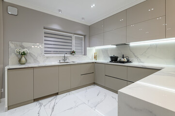Luxury white modern marble kitchen in studio space - obrazy, fototapety, plakaty