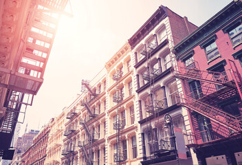 New York cityscape with old buildings with fire escapes, color toning applied, USA.