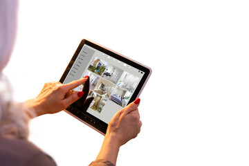 young woman sitting at modern home using smart home station.
