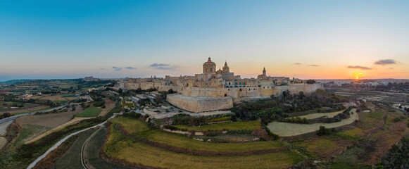 Evening sunset panorama of Mdina city - old capital of Malta.  Nature landscape, sunset sky