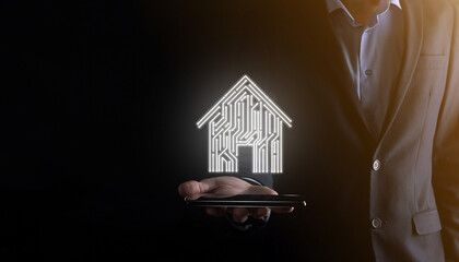 Businessman hold house icon.Smart home controlled, intelligent house, and home automation app...