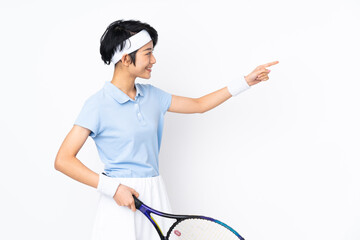 Young Vietnamese tennis player woman over isolated white wall playing tennis