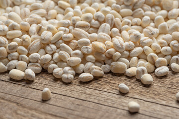 pearl barley on wooden textured background
