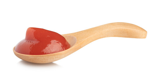 tomato ketchup in a special wooden spoon for sauces isolated on white