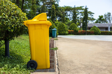 Yellow plastic bins located in the park.