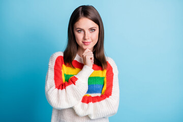 Photo of charming thoughtful young woman dressed striped sweater arm chin empty space smiling isolated blue color background