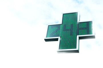 Green pharmacy cross indicating 24 hours of opening