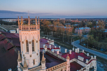Panoramic aerial view of the New Peterhof railway station in the Pseudo-Gothic style. The western facade of the building is in the form of a four-tiered tower. Russia, Peterhof, 20.10.2020.