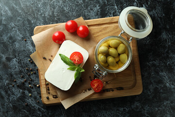 Concept of tasty food with feta cheese on black smokey background