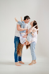 beautiful happy family at a photo shoot in a white photo studio. backstage.