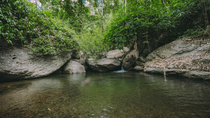 Waterfall in the forest in the middle of the valley.