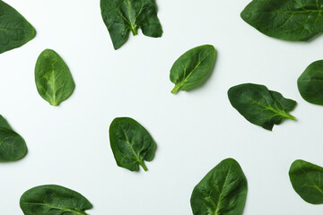 Fresh raw spinach leaves on white background