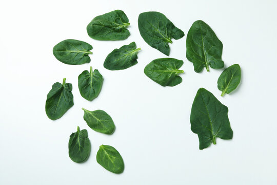 Fresh raw spinach leaves on white background