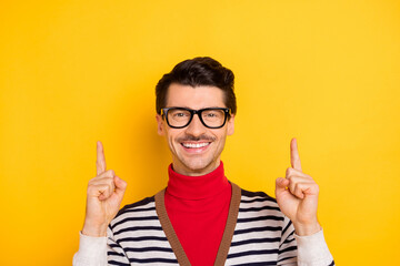 Photo of young guy happy positive smile indicate fingers empty space ad promo advise choice way...