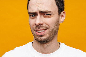 Fototapeta premium Mid aged brunette casual man in t-shirt standing isolated