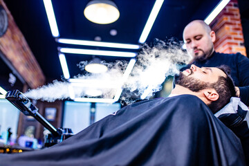 arabic handsome bearded man getting condensation moisture haircut at barbershop