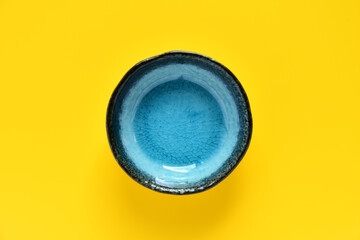 Ceramic plate on color background