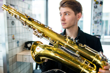 Male jazz musician playing a saxophone in a restaurant