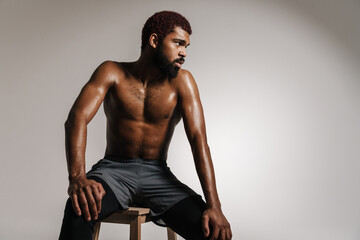 Fototapeta na wymiar Tired sweaty afro american sportsman resting after workout