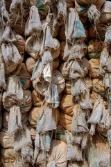 Pile of old dirty sand bags used as fortification of an army checkpoint close up