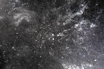 Black table background with sugar cooking powder, kitchen mess
