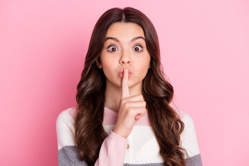 Fototapeta premium Photo of young preteen girl cover finger lips keep secret no talk rumor gossip private information isolated over pink color background