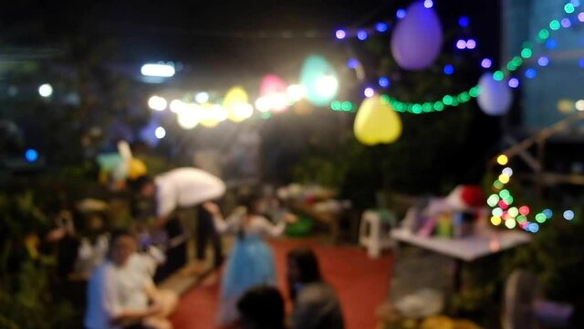 Blurred people in daughter birthday party at home in night. happy event time. Out of focus video.