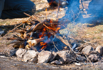 bonfire burning, bright sunny day, beautiful nature, travel, hiking and camping concept