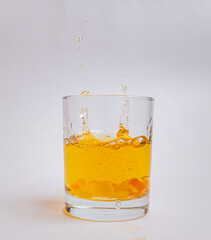 glass of apple juice with pulp and splashes