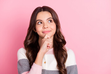 Photo of dreamy lovely young girl look empty space hold hand chin imagine isolated on pink color...
