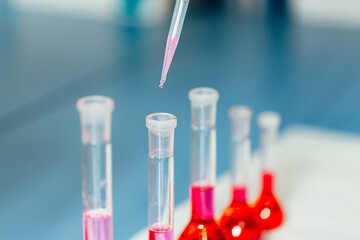 Science laboratory test tube and pipet with drop, laboratory equipment closeup