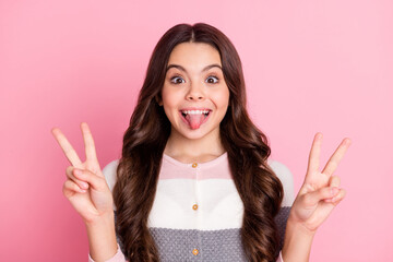 Photo of young school girl happy smile grimace fooling tongue-out show peace cool v-sign isolated over pastel color background