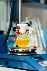 flask with laboratory glassware in the background of a chemical laboratory, research and development concept of a science laboratory