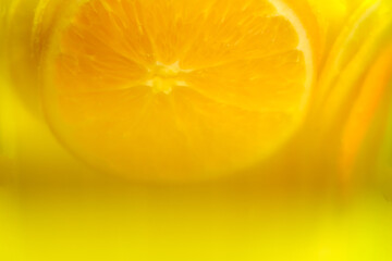 Food background, orange drink behind glass with citrus inside