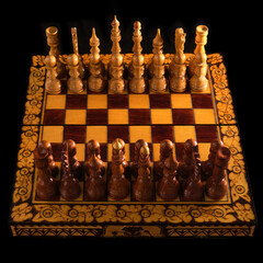 Carved chess pieces are placed opposite each other before the start of the game