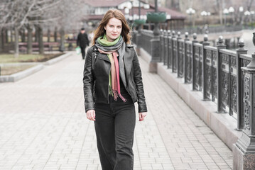 Portrait of a young girl who poses while walking in cloudy weather