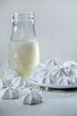 meringues and milk on a light background