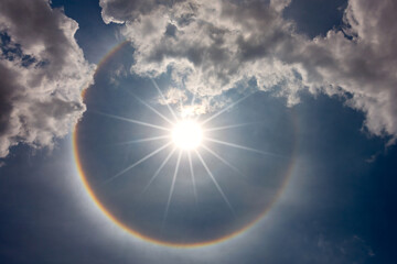 fantastic beautiful sun halo phenomenon in Thailand. Lens flare effects on golden suns with  Light particles and rainbow halo.