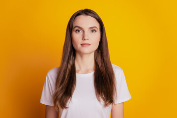 Photo of calm peaceful lady wear white t-shirt posing on yellow background