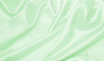 Smooth elegant green silk or satin luxury cloth texture as abstract background. Luxurious...