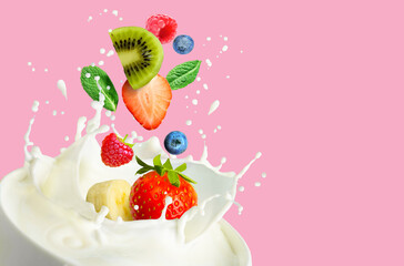 Fruit and bery mix falling into the bowl with milk and splashing on a pink background.