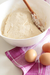 bread backing, fresh dough with eggs on pink towel