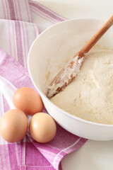 bread backing, fresh dough with eggs on pink towel