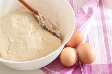 bread backing, fresh dough with eggs on pink towel