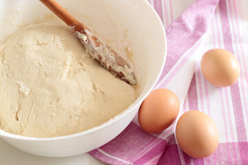 bread backing, fresh dough with eggs on pink towel