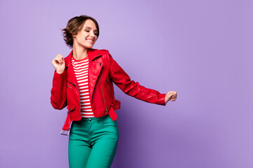 Photo of young attractive girl happy positive smile dance look empty space isolated over purple color background