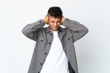 Young brazilian man isolated on white background frustrated and covering ears