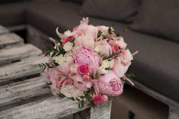 Pink wedding bouquet, composed of roses, freesias, peonies, hypericum, astilba and eucalypthus.